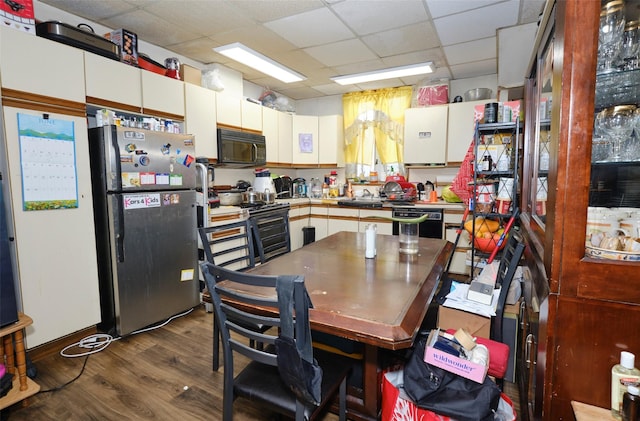 99 Pioneer St, Brooklyn, NY 11231 - kitchen featuring black appliances, a paneled ceiling, dark wood-style flooring, and white cabinets