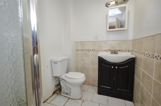99 Pioneer St, Brooklyn, NY 11231 - full bath with tile walls, vanity, a shower with shower door, tile patterned floors, and a wainscoted wall