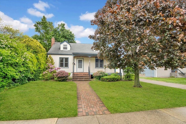 23 Lenox Pl, Freeport, NY 11520 - view of front facade with a chimney, a front lawn, a porch, and roof with shingles