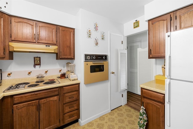 16 Fairway Dr, Eldred, NY 12743 - kitchen featuring freestanding refrigerator, wall oven, electric stovetop, under cabinet range hood, and light countertops