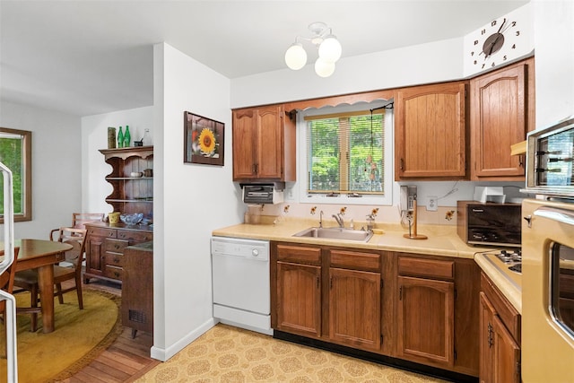 16 Fairway Dr, Eldred, NY 12743 - kitchen featuring dishwasher, a sink, light countertops, brown cabinets, and light wood-style floors