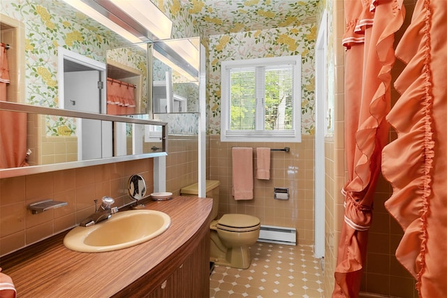16 Fairway Dr, Eldred, NY 12743 - bathroom with wallpapered walls, a baseboard heating unit, tile walls, toilet, and vanity