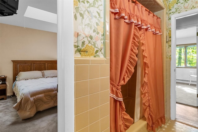 16 Fairway Dr, Eldred, NY 12743 - carpeted bedroom with a baseboard heating unit, a skylight, and wallpapered walls