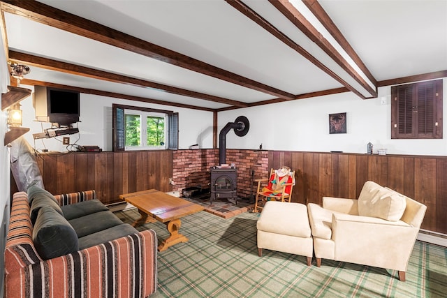 16 Fairway Dr, Eldred, NY 12743 - living room featuring wood walls, beamed ceiling, wainscoting, a wood stove, and a baseboard radiator