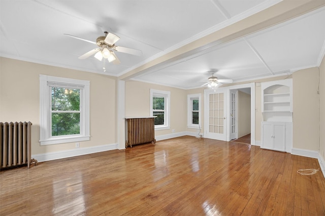 108 Union Ave, Peekskill, NY 10566 - unfurnished living room with radiator, a ceiling fan, plenty of natural light, hardwood / wood-style flooring, and crown molding