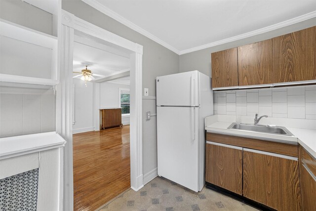 108 Union Ave, Peekskill, NY 10566 - kitchen featuring freestanding refrigerator, crown molding, brown cabinets, ceiling fan, and light countertops