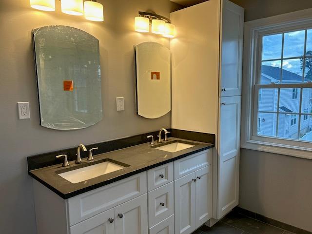 51 Michigan Ave, Massapequa, NY 11758 - full bathroom with double vanity, tile patterned flooring, and baseboards