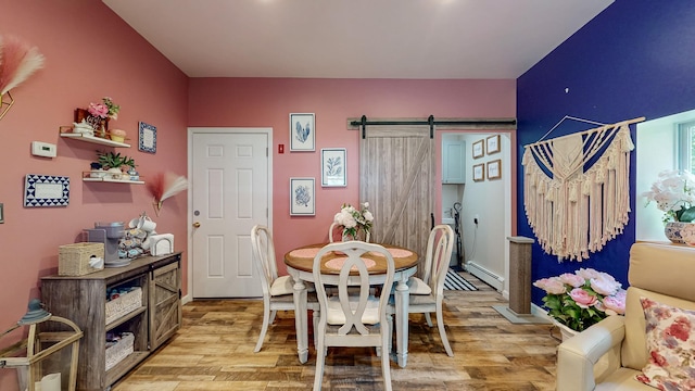 7 Didio Ln, Montgomery, NY 12549 - dining space featuring a baseboard radiator, light wood finished floors, and a barn door
