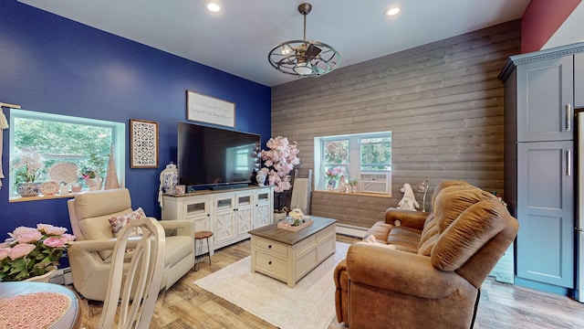 7 Didio Ln, Montgomery, NY 12549 - living area featuring wood walls, recessed lighting, light wood-style floors, an accent wall, and baseboard heating