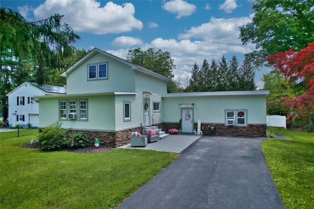 7 Didio Ln, Montgomery, NY 12549 - view of front facade with stone siding, stucco siding, a front yard, and cooling unit