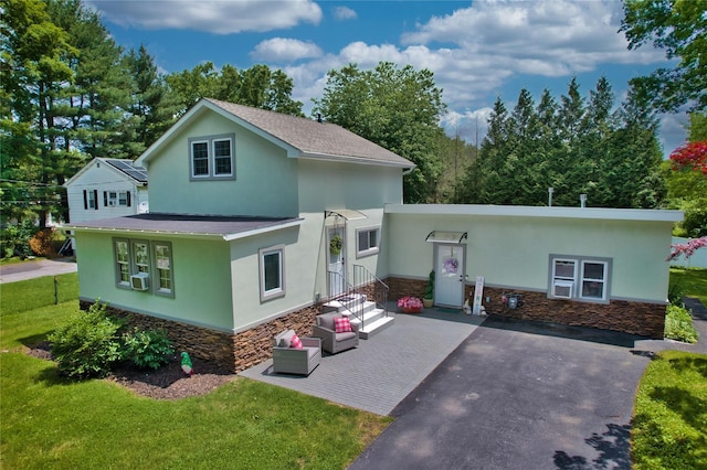 7 Didio Ln, Montgomery, NY 12549 - view of front of house featuring stone siding, stucco siding, a front lawn, a shingled roof, and an outdoor living space