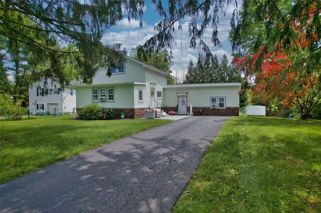 7 Didio Ln, Montgomery, NY 12549 - view of front of home with stucco siding, stone siding, driveway, and a front lawn