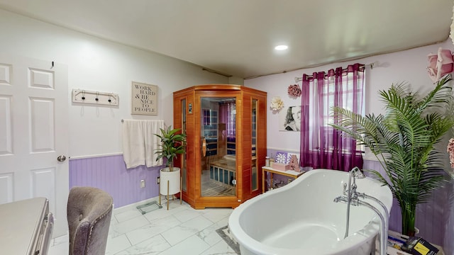 7 Didio Ln, Montgomery, NY 12549 - bathroom featuring wainscoting, a freestanding bath, and marble look tile flooring