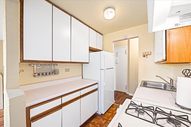 2015 St Paul Ave Unit 3G, Bronx, NY 10461 - kitchen with a sink, freestanding refrigerator, light countertops, white cabinetry, and parquet floors