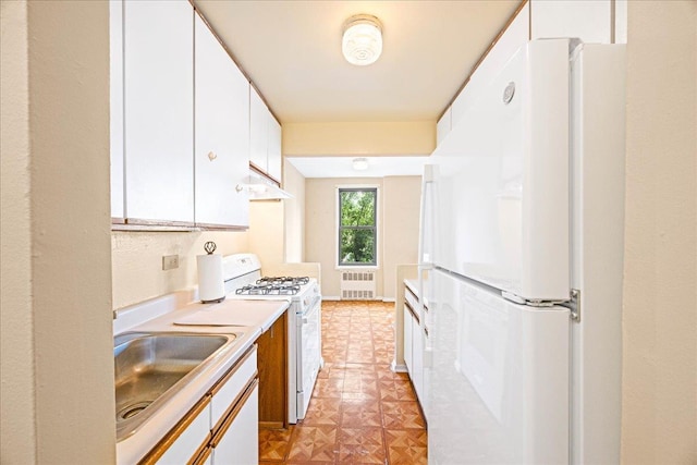 2015 St Paul Ave Unit 3G, Bronx, NY 10461 - kitchen featuring radiator heating unit, white appliances, a sink, white cabinetry, and under cabinet range hood