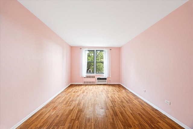 2015 St Paul Ave Unit 3G, Bronx, NY 10461 - spare room featuring wood finished floors, radiator, baseboards, and a wall unit AC