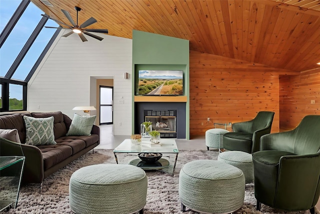 356 Bruyn Tpke, Wallkill, NY 12589 - living area with ceiling fan, wooden walls, wooden ceiling, a glass covered fireplace, and high vaulted ceiling