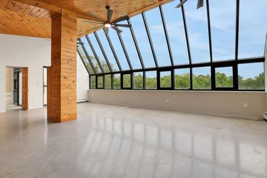 356 Bruyn Tpke, Wallkill, NY 12589 - unfurnished living room with wooden ceiling, a towering ceiling, and a ceiling fan