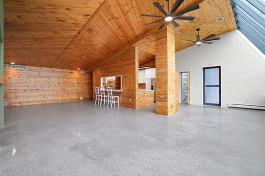 356 Bruyn Tpke, Wallkill, NY 12589 - unfurnished living room with wood ceiling, ceiling fan, a baseboard radiator, vaulted ceiling, and wood walls