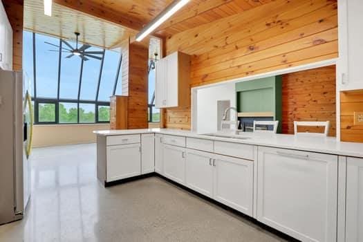 356 Bruyn Tpke, Wallkill, NY 12589 - kitchen with stainless steel refrigerator with ice dispenser, ceiling fan, wood walls, white cabinets, and wooden ceiling