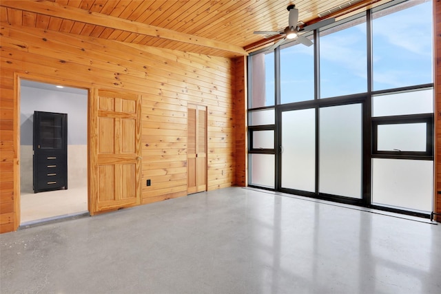 356 Bruyn Tpke, Wallkill, NY 12589 - unfurnished room with ceiling fan, concrete floors, and wood walls