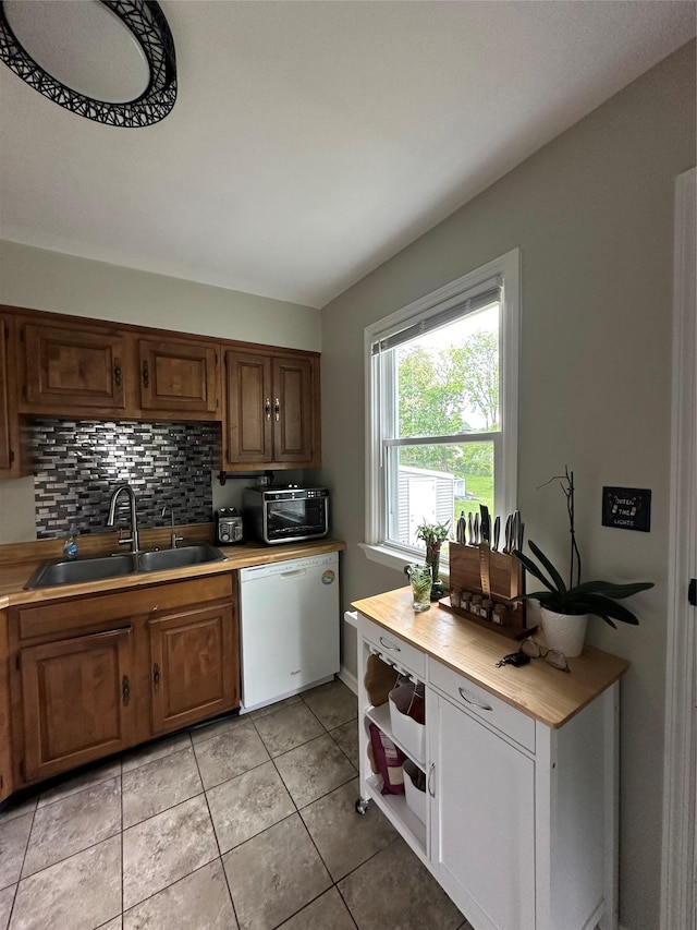 8 Spratt Ave, Poughkeepsie, NY 12603 - kitchen featuring dishwasher, a sink, tasteful backsplash, light tile patterned floors, and light countertops