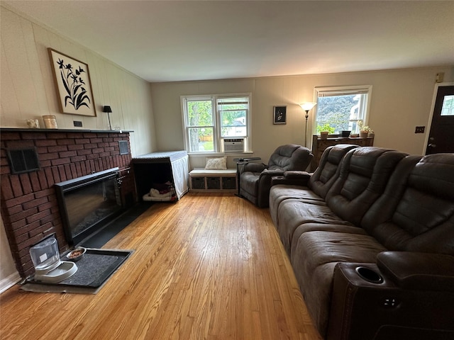 8 Spratt Ave, Poughkeepsie, NY 12603 - living room with light wood-style floors, a brick fireplace, and cooling unit