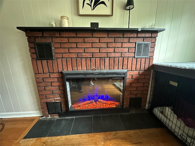 8 Spratt Ave, Poughkeepsie, NY 12603 - detailed view of a brick fireplace, wood finished floors, and baseboards