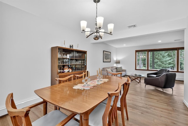 11 Robin Hood Rd, Montebello, NY 10901 - dining space featuring a chandelier, light wood-style flooring, recessed lighting, and a baseboard heating unit