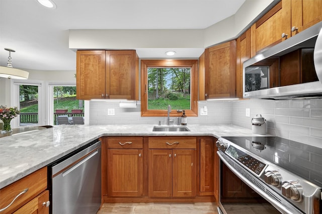 11 Robin Hood Rd, Montebello, NY 10901 - kitchen featuring appliances with stainless steel finishes, brown cabinets, light stone counters, and decorative backsplash