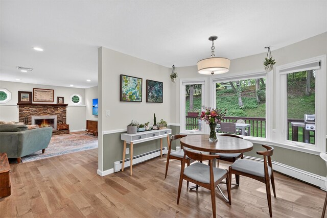 11 Robin Hood Rd, Montebello, NY 10901 - dining area featuring a baseboard radiator, light wood finished floors, recessed lighting, and a fireplace