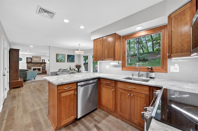 11 Robin Hood Rd, Montebello, NY 10901 - kitchen featuring appliances with stainless steel finishes, a peninsula, brown cabinetry, and recessed lighting