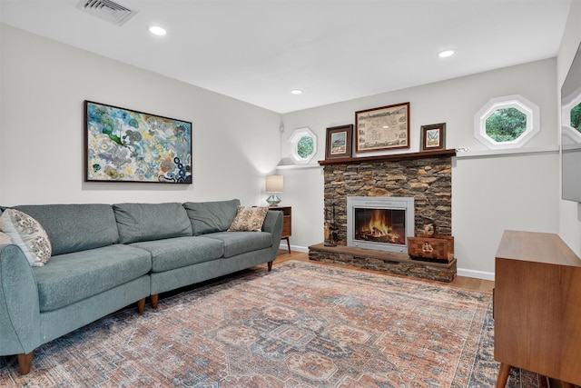 11 Robin Hood Rd, Montebello, NY 10901 - living area with plenty of natural light, wood finished floors, a stone fireplace, and recessed lighting