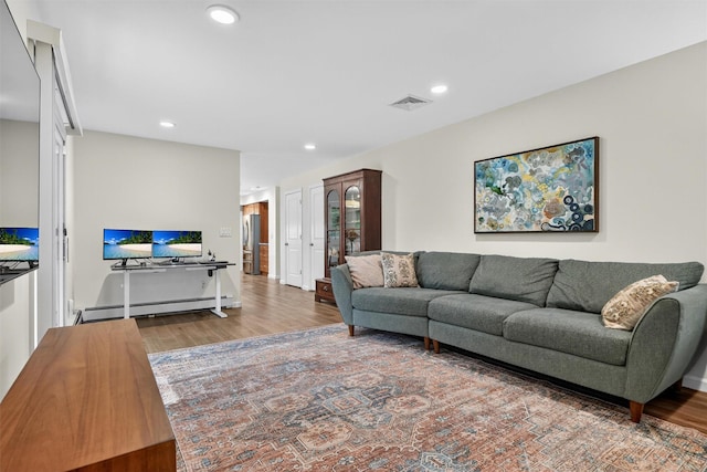 11 Robin Hood Rd, Montebello, NY 10901 - living room featuring baseboard heating, wood finished floors, and recessed lighting