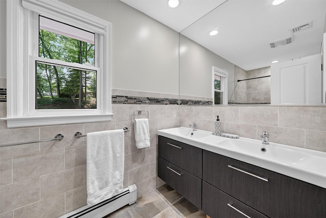 11 Robin Hood Rd, Montebello, NY 10901 - full bath with baseboard heating, double vanity, a tile shower, tile walls, and recessed lighting