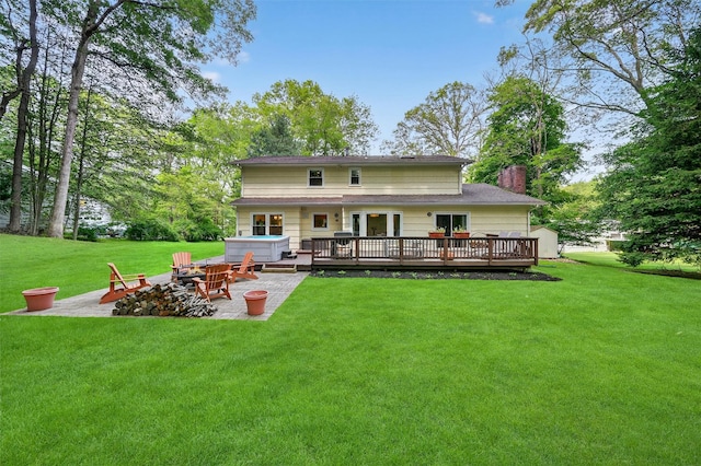 11 Robin Hood Rd, Montebello, NY 10901 - rear view of house featuring an outdoor fire pit, a deck, a patio, a lawn, and a chimney