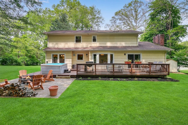 11 Robin Hood Rd, Montebello, NY 10901 - rear view of property with a hot tub, a patio, a wooden deck, a chimney, and a lawn