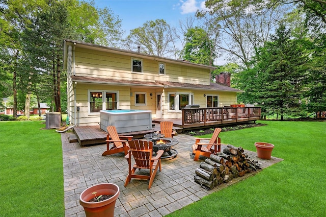 11 Robin Hood Rd, Montebello, NY 10901 - back of property featuring a fire pit, a hot tub, a patio, and a deck