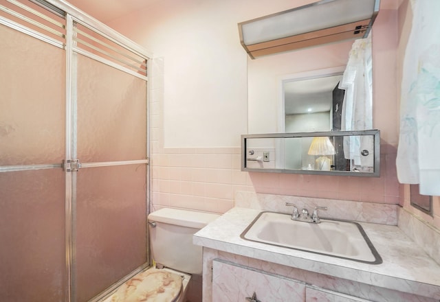 239 Lake St, West Harrison, NY 10604 - full bathroom featuring vanity, a shower with shower door, and tile walls