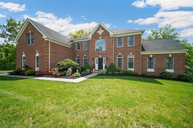 27 Sommerset Dr, Poughkeepsie, NY 12603 - view of front of property with brick siding, a front lawn, and a shingled roof