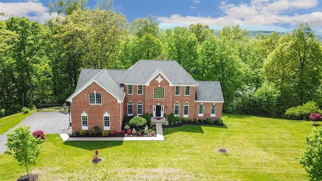 27 Sommerset Dr, Poughkeepsie, NY 12603 - colonial inspired home featuring brick siding, a front lawn, and roof with shingles