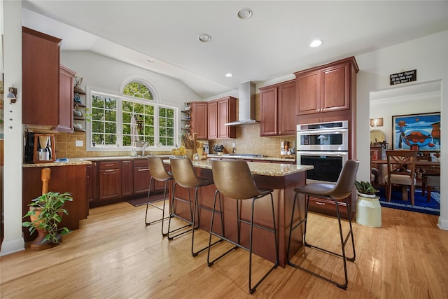 27 Sommerset Dr, Poughkeepsie, NY 12603 - kitchen featuring wall chimney range hood, appliances with stainless steel finishes, open shelves, a center island, and a breakfast bar