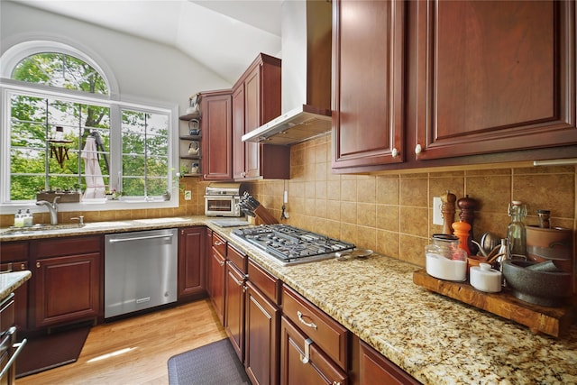 27 Sommerset Dr, Poughkeepsie, NY 12603 - kitchen featuring stainless steel appliances, wall chimney exhaust hood, vaulted ceiling, light stone countertops, and light wood-style flooring