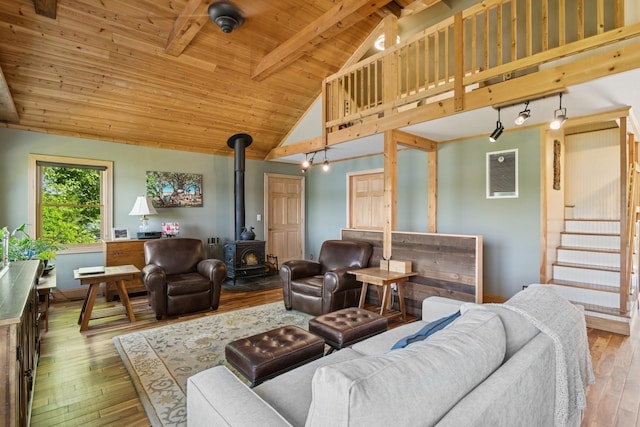 129 W Lakeshore Dr, Carmel, NY 10512 - living area with a wood stove, high vaulted ceiling, wood-type flooring, wood ceiling with exposed beams, and baseboards