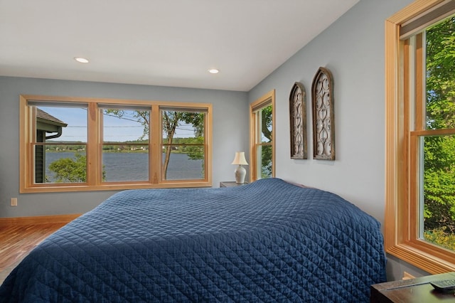 129 W Lakeshore Dr, Carmel, NY 10512 - bedroom with multiple windows, a water view, recessed lighting, and wood finished floors