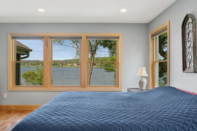 129 W Lakeshore Dr, Carmel, NY 10512 - bedroom with multiple windows, wood finished floors, a water view, and recessed lighting