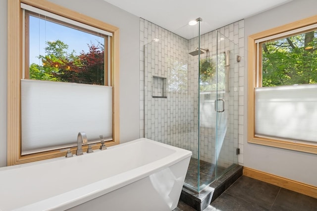 129 W Lakeshore Dr, Carmel, NY 10512 - bathroom featuring a soaking tub, a shower stall, tile patterned flooring, and baseboards