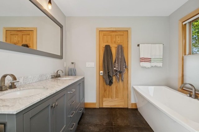 129 W Lakeshore Dr, Carmel, NY 10512 - full bath with double vanity, a freestanding bath, and baseboards
