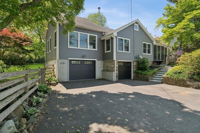 129 W Lakeshore Dr, Carmel, NY 10512 - view of front of home featuring stairway, asphalt driveway, an attached garage, and stone siding