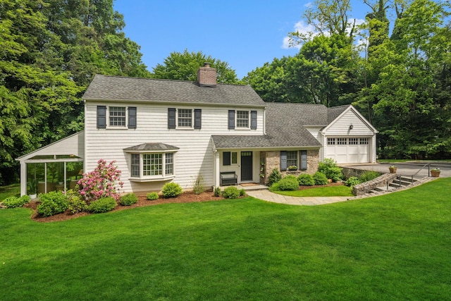 33 High Way, Chappaqua, NY 10514 - view of front of house featuring a chimney, a front lawn, roof with shingles, an attached garage, and concrete driveway